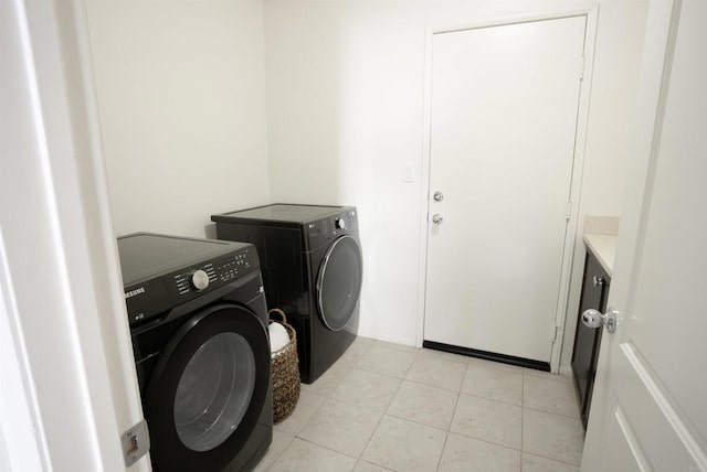 washroom with washing machine and dryer and light tile patterned floors