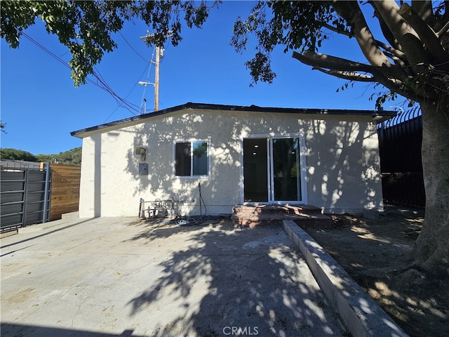 back of house with a patio