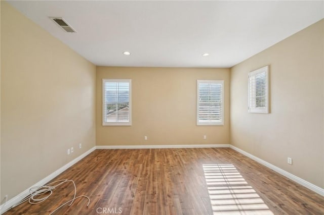 spare room with wood-type flooring