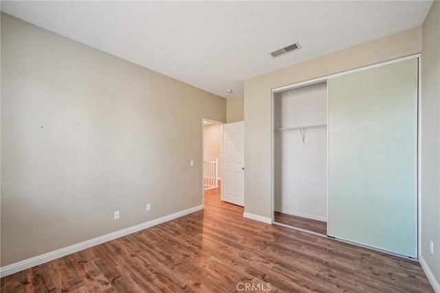 unfurnished bedroom featuring a closet and wood-type flooring