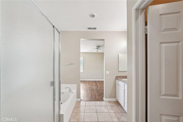 bathroom featuring ceiling fan, a bathtub, tile patterned floors, and vanity