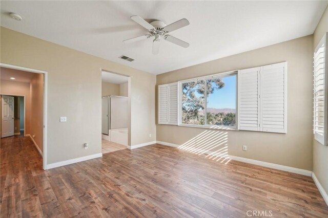 spare room featuring ceiling fan and light hardwood / wood-style flooring