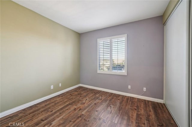 empty room featuring dark hardwood / wood-style flooring