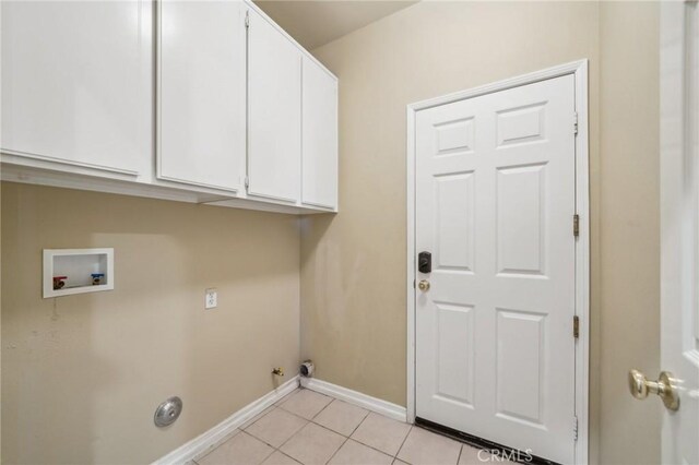 clothes washing area featuring cabinets, light tile patterned flooring, hookup for a gas dryer, and washer hookup