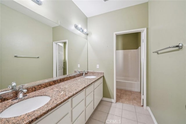 bathroom featuring a shower, tile patterned floors, and vanity