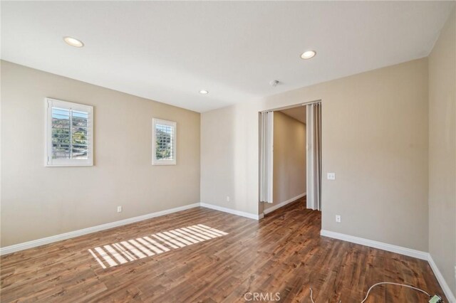 unfurnished room featuring dark wood-type flooring