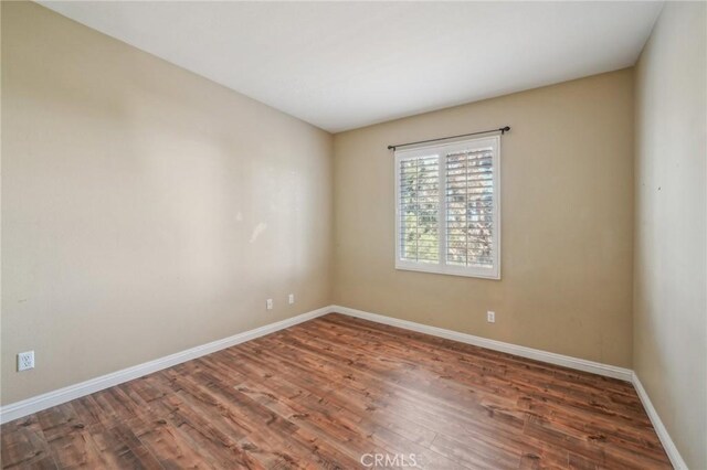 unfurnished room featuring dark hardwood / wood-style flooring