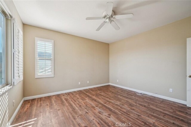 spare room with ceiling fan and wood-type flooring