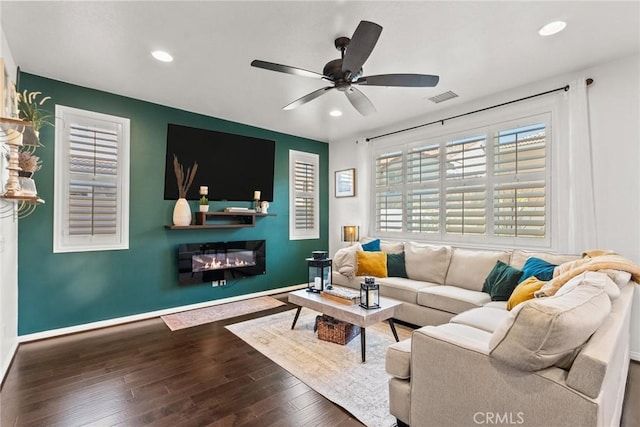 living room with ceiling fan and dark hardwood / wood-style floors