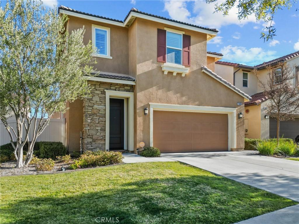 mediterranean / spanish house with a front lawn and a garage