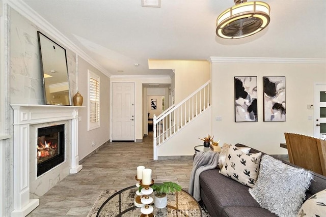 living room featuring crown molding and light hardwood / wood-style flooring