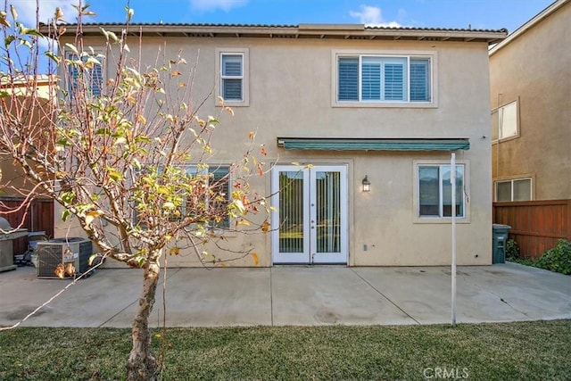 rear view of house featuring a patio, french doors, and central AC