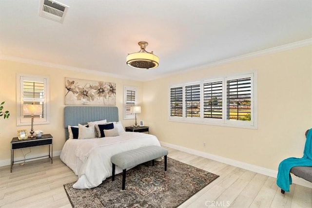 bedroom with multiple windows, crown molding, and light wood-type flooring