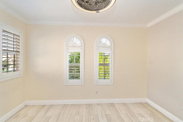 empty room featuring light wood-type flooring and crown molding