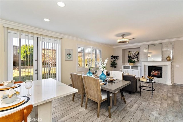 dining area featuring crown molding and light hardwood / wood-style flooring