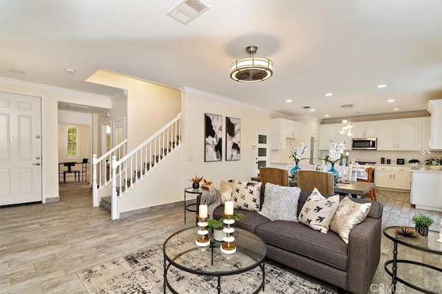 living room featuring ornamental molding and light hardwood / wood-style flooring