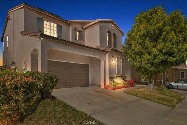 mediterranean / spanish-style house featuring a garage