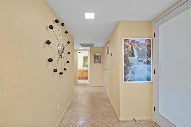 corridor with light tile patterned floors