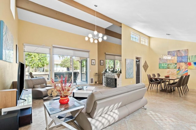 living room featuring a healthy amount of sunlight, a high ceiling, a chandelier, and light tile patterned floors