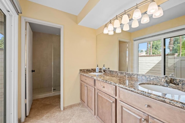 bathroom with walk in shower, tile patterned floors, and vanity