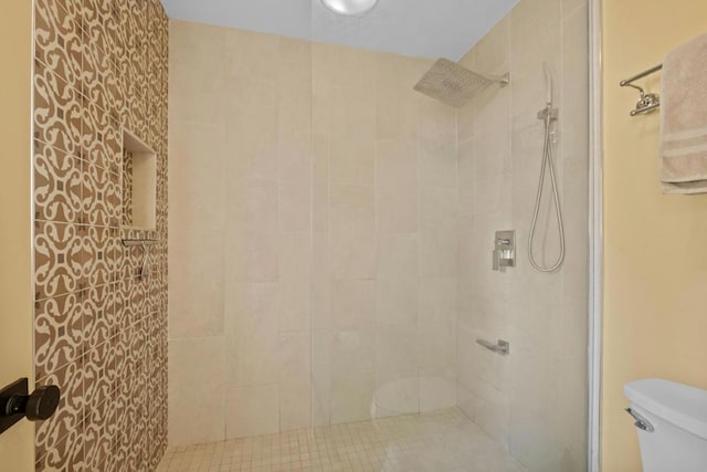 bathroom featuring toilet and tiled shower