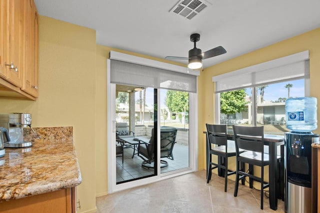 dining space featuring ceiling fan and light tile patterned floors