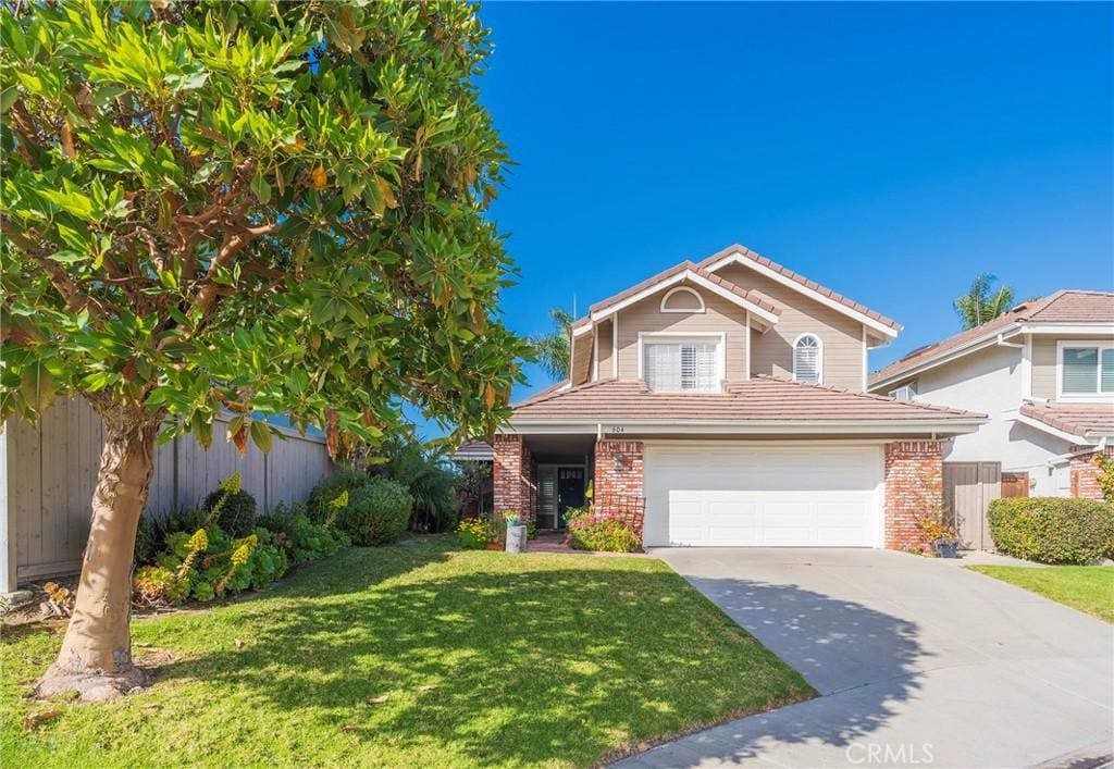 front of property featuring a front yard and a garage