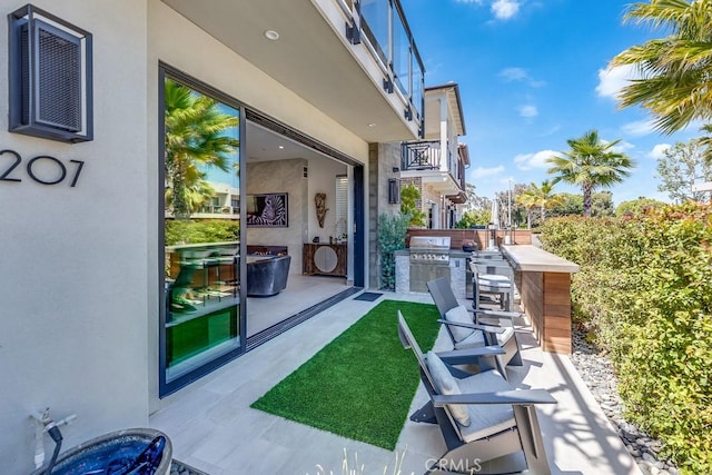 view of patio featuring a bar and area for grilling