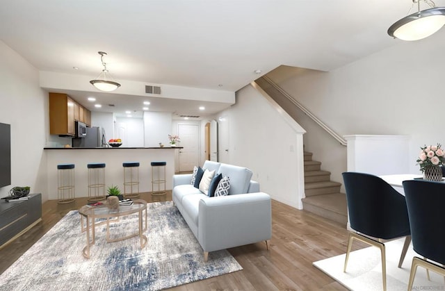 living room with light hardwood / wood-style flooring