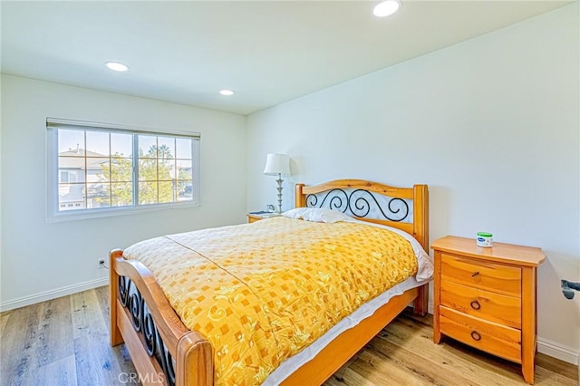 bedroom with hardwood / wood-style floors