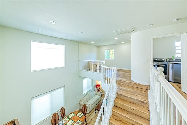 hall featuring light hardwood / wood-style floors and washer and clothes dryer