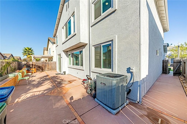 back of house featuring central air condition unit and a patio