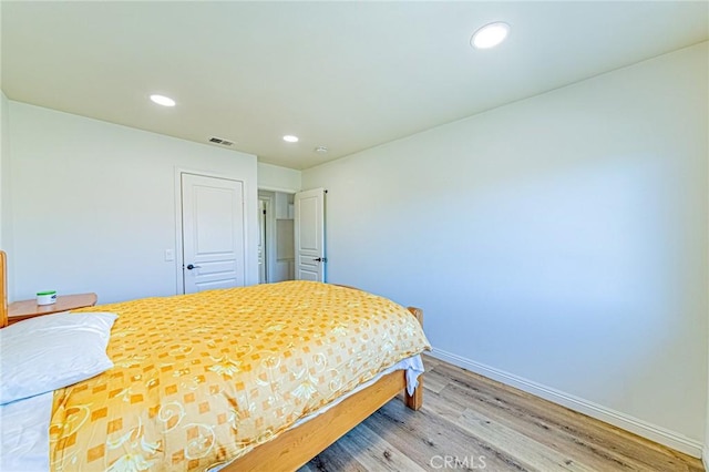 bedroom with wood-type flooring