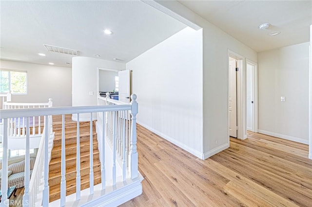 hallway with light hardwood / wood-style floors