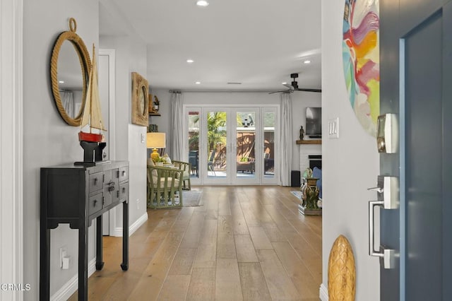 entryway with ceiling fan and light hardwood / wood-style flooring