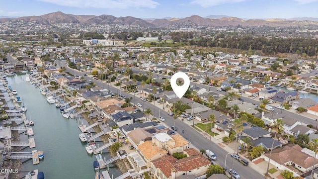 birds eye view of property featuring a water and mountain view