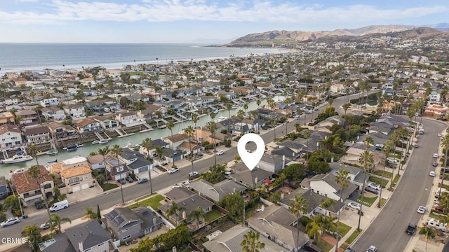 drone / aerial view featuring a water and mountain view