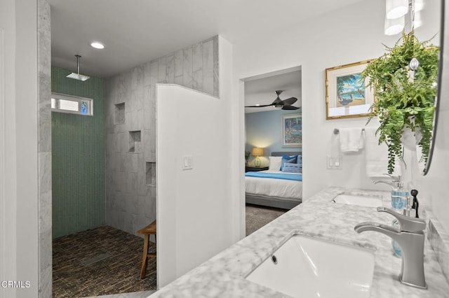 bathroom featuring a tile shower, ceiling fan, and vanity