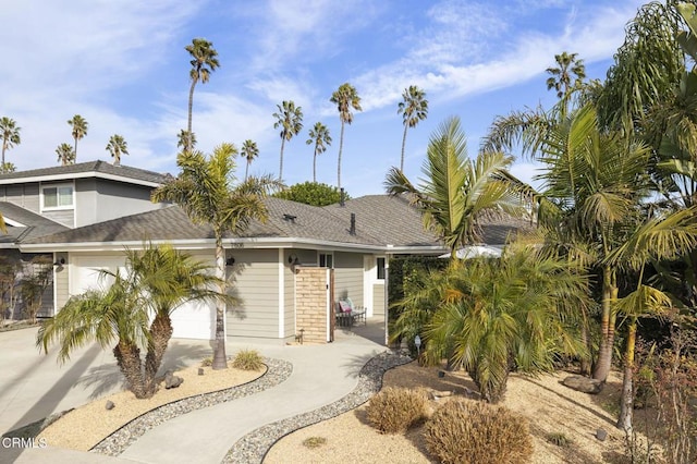 view of front of house with a patio area and a garage