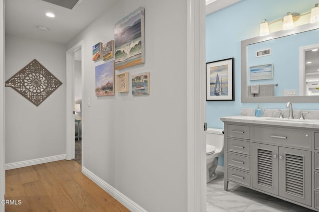 hall featuring light hardwood / wood-style flooring and sink