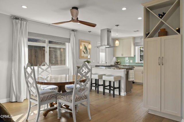 dining area featuring ceiling fan and light hardwood / wood-style floors