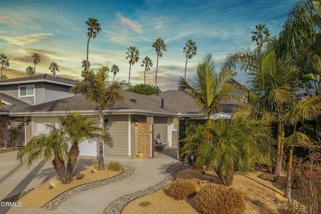 view of front of house with a garage and a patio