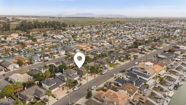 birds eye view of property with a water and mountain view