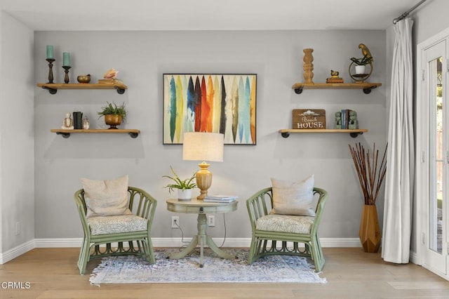 sitting room featuring light hardwood / wood-style flooring