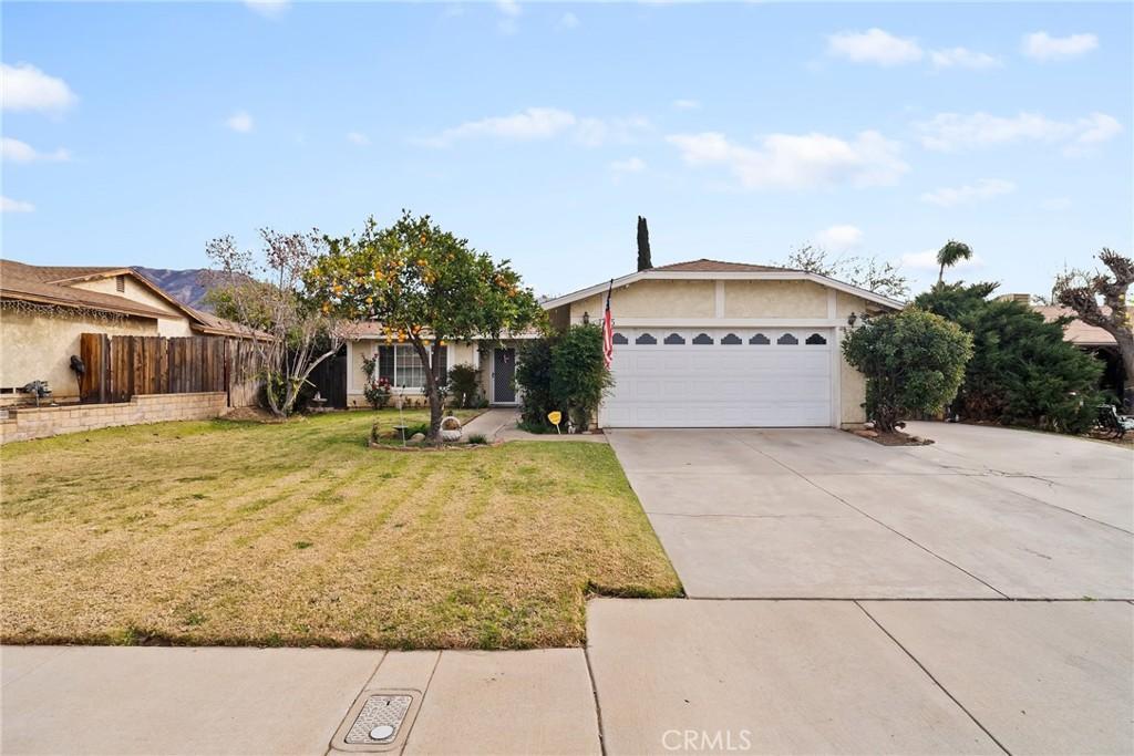 ranch-style home with a garage and a front yard