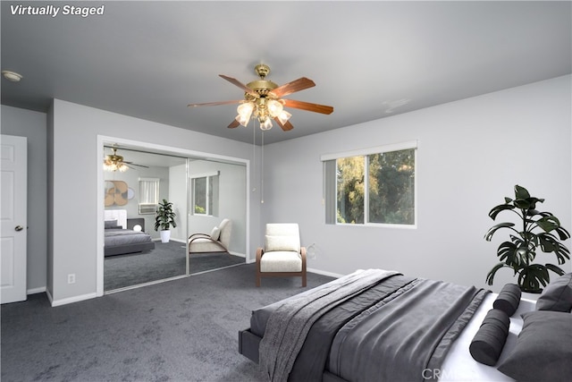 bedroom featuring ceiling fan, a closet, multiple windows, and dark colored carpet