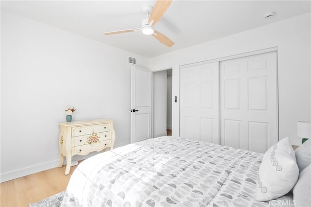 bedroom with a closet, ceiling fan, and hardwood / wood-style flooring