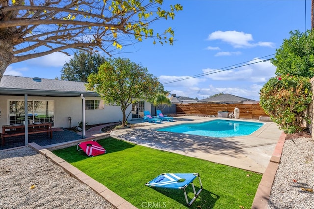 view of pool featuring a patio area and a yard