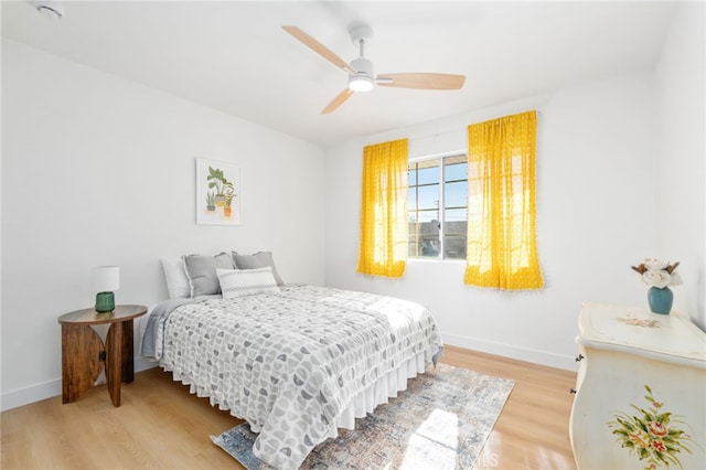 bedroom with ceiling fan and light wood-type flooring