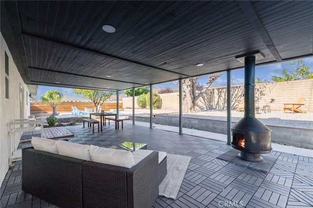 view of patio with an outdoor living space with a fire pit